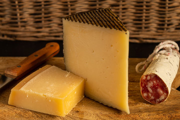 Cheese board and Iberian sausage on slate stone