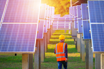 Solar power plant,engineers walking in the solar energy panels,Technician with field of solar panels