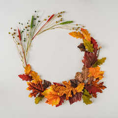 Creative season layout of colorful autumn leaves and branches. Nature mockup background. Seasonal concept. Flat lay wreath.
