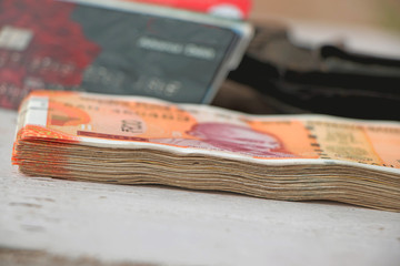 India paper currency and wallet with debit and credit card in the background 