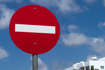 No entry traffic sign in front of blue sky
