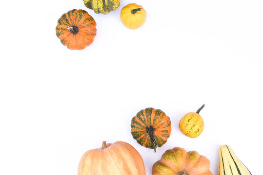 Autumn flat lay on an isolated white background made of pumpkins.