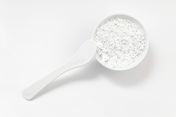 Closeup ingredient for alginate cosmetic mask and paddle for applying it on white background. Top view.