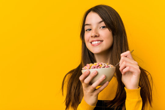 Little caucasian girl holding a cereal bowl