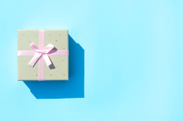 Gift box on a blue background with hard light.
