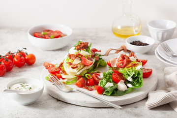 romaine lettuce topped with bacon tomato parmesan, sauce. healthy keto paleo diet lunch