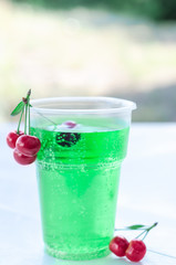 Lemonade in a plastic Cup, outdoors. Selective focus