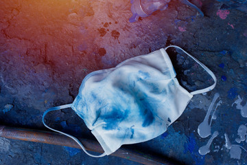 Dirty protective mask on cement floor, contaminated mask, Pollution protection work concept.