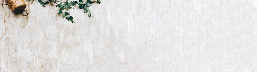 Floral background. Craft arrangement. Laurel decor twine cord on beige textured surface.