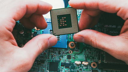 Electronic engineering. Hardware maintenance. Technician installing CPU microprocessor.