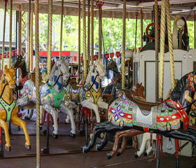 Fototapeta na wymiar Merry-go-round with horses. Carousel with horses. Amusement Park in the city