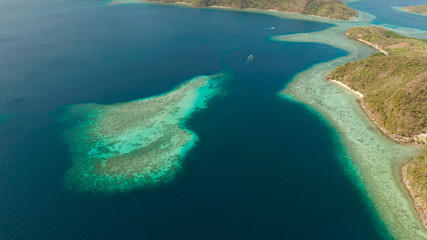 Fototapeta na wymiar aerial view tropical islands with blue lagoon, coral reef and sandy beach. Palawan, Philippines. Islands of the Malayan archipelago with turquoise lagoons.