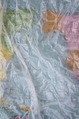Clear plastic bag texture background. Earth map. Waste recycling concept. Crumpled polyethylene and cellophane.