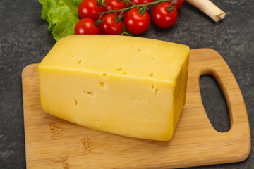 Hard yellow tasty cheese brick