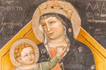 Ruins of medieval religious fresco showing byzantine icon of Mary and Jesus as a child © Giorgio G