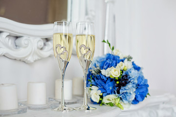champagne glasses for newlyweds near the bride's wedding bouquet
