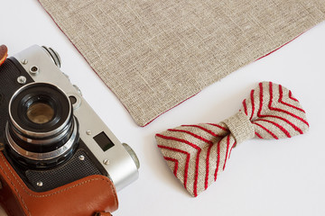 Still life with bow ties, and old analog film camera. Bow ties with embroidery.  Men's accessories....