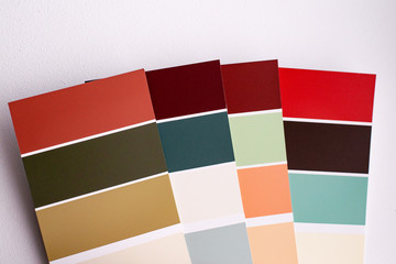 Color palette with various samples. Light background. Paint selection cards, close-up.