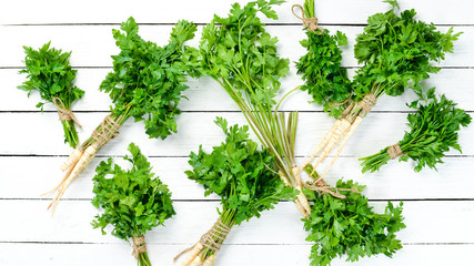 Parsley root on a white wooden background. Top view. Free space for your text.