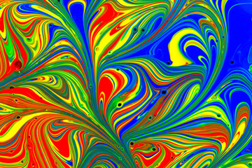 Multicolored abstract background pattern created with red, yellow, blue and green liquid paint swirls