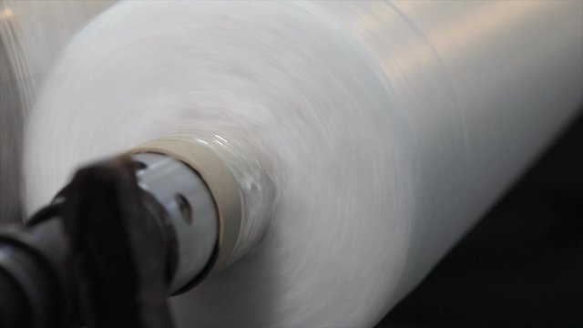 Rolls of non-woven fabric are being pushed into the tube. Nonwoven fabric production