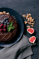 chocolate cake with fresh berries and nuts
