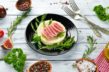Tuna fillet and couscous. Dishes menu. Free copy space. Top view.