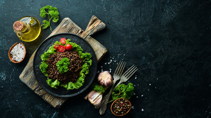 Boiled lentils with vegetables. Dishes menu. Free copy space. Top view.