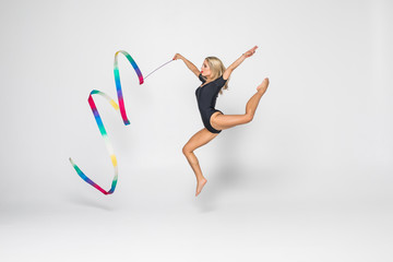 Rhythmic gymnast with gymnastics tape isolated on white background