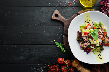 Vegetable salad with tuna and quail eggs. Food. Top view. Free space for your text.