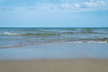 Beautiful waves rolling up on a sandy beach. Summertime in Österlen, Sweden.