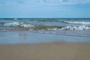 Beautiful waves rolling up on a sandy beach. Summertime in Österlen, Sweden.