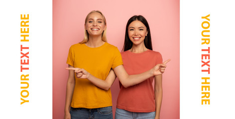 Two girls indicates something. Joyful expression face. Pink background with blank space for your text