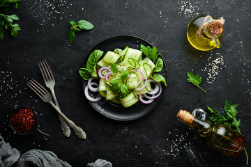 Salad of fresh cucumbers and onions. Top view. Free space for your text.