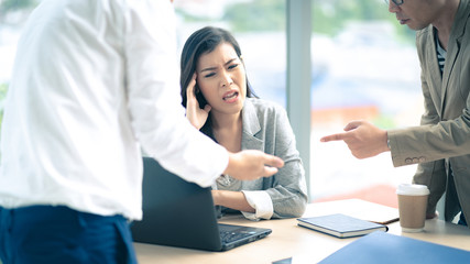 Stressing from work - Asian businesswoman gets overwhelmed from her colleagues during the meeting.