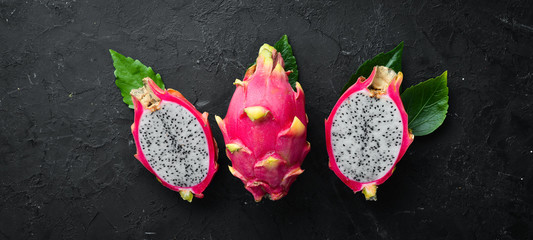 Fresh Pytahya on a black background. Dragon Fruit. Tropical Fruits. Top view. Free space for text.
