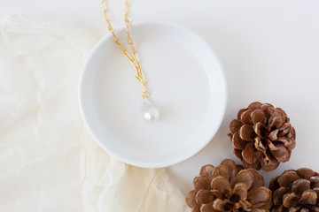 Large Pearl Pendent on Gold Chain Displayed on Tray