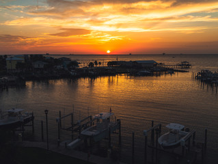 Golden hour sunset over a boat marina.