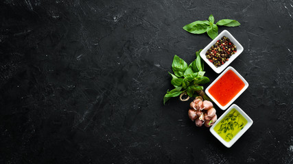 Set sauces and spices. On a wooden background. Top view. Free space for your text.