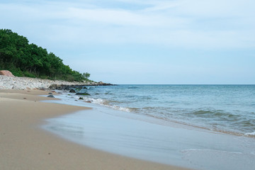 Beautiful waves rolling up on a sandy beach. Summertime in Österlen, Sweden.