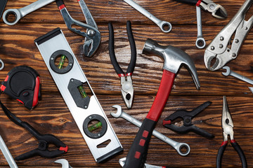 Close up tools on a wooden background.
