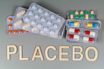 Packs of pills and placebo written in wooden letters