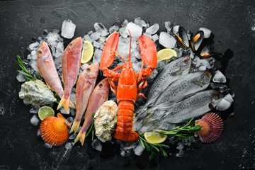 Seafood on stone background. Lobster, fish, shellfish. Top view. Free copy space.