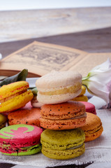 Sweet and colorful macarons. Closeup macaroons on a plate. Tasty french delicate dessert for breakfast. Vintage tone style.