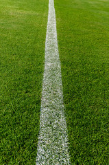 The white Line marking on the artificial green grass soccer field.