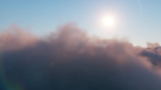 Flight through moving cloudscape with beautiful sun rays. Beautiful realistic flight over cumulus lush clouds at sunset. Seamless loop 3d render