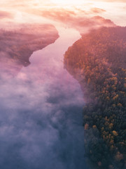 Aerial shot of foggy autumn morning on the river.
