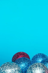 Christmas decoration over blue background. Holidays, Christmas toys concept. Blue, red and silver Christmas balls over blue background.