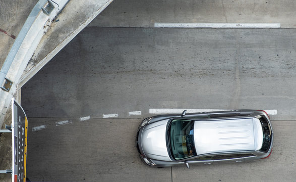 Aerial View Of Silver Car In Airport With Copy Space. Top View Of Vehicle On Street