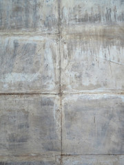 Concrete gray scratched wall of square blocks.